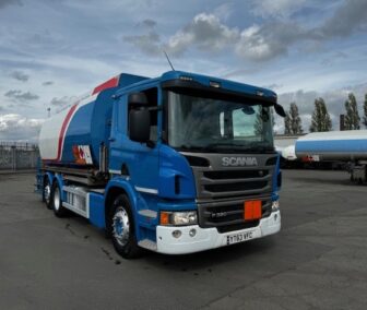 Front view of a Scania P320 fuel tanker, featuring front-mounted delivery hose and reel for efficient fuel dispensing.