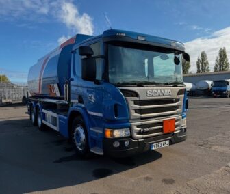 Front View: Front view of a Scania P320 fuel tanker featuring a front-mounted delivery hose and reel for efficient fuel dispensing.