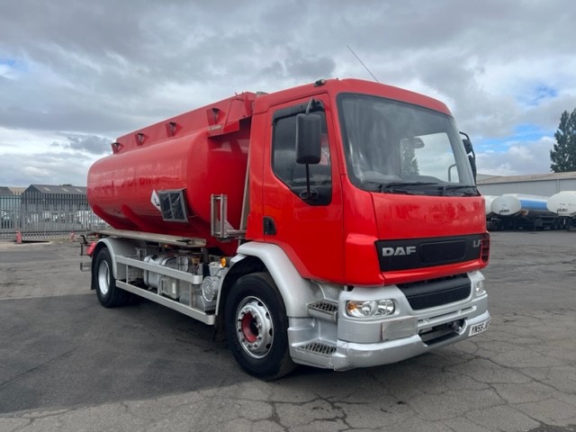 DAF tanker truck, large tank with red bodywork, white metal wheels and headlights, parked in carpark.