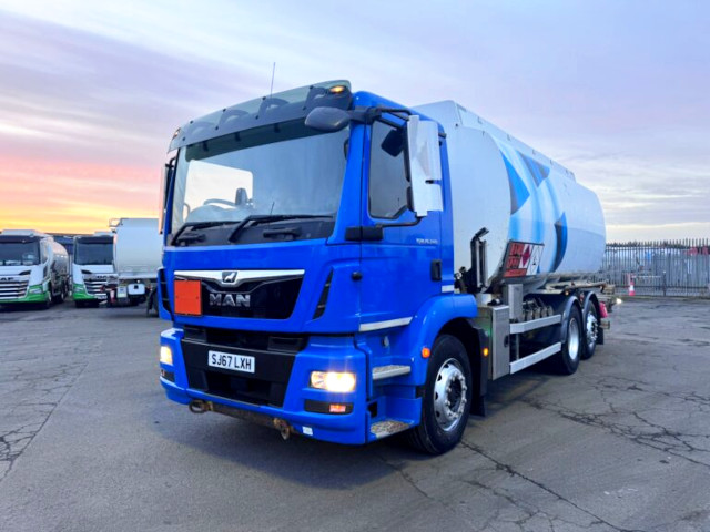 Top 10 used trucks for malta: man tgm tanker truck in vibrant blue captured at sunset, showing front 3/4 view with led lights"