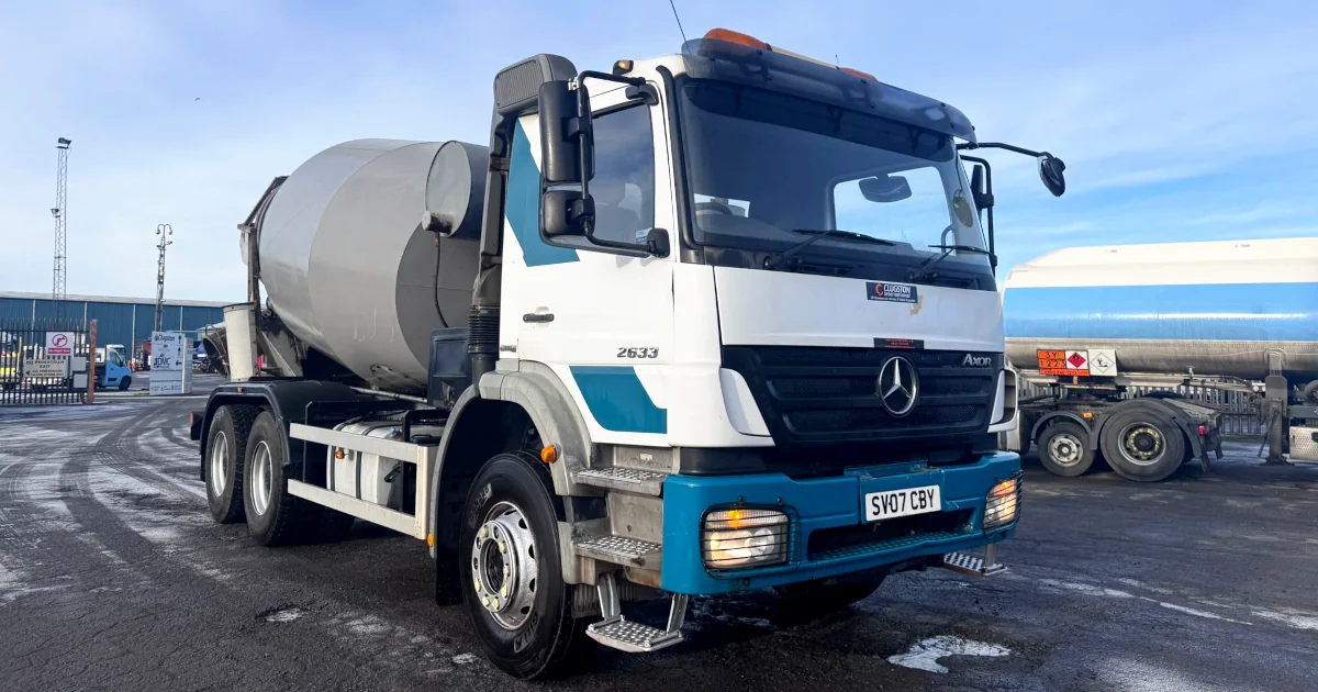 Used Mercedes-Benz Axor 2633 concrete mixer truck featuring McPhee 6m³ barrel, 6X4 configuration, Euro 4, white and blue livery, registration SV07 CBY, photographed at Scunthorpe yard