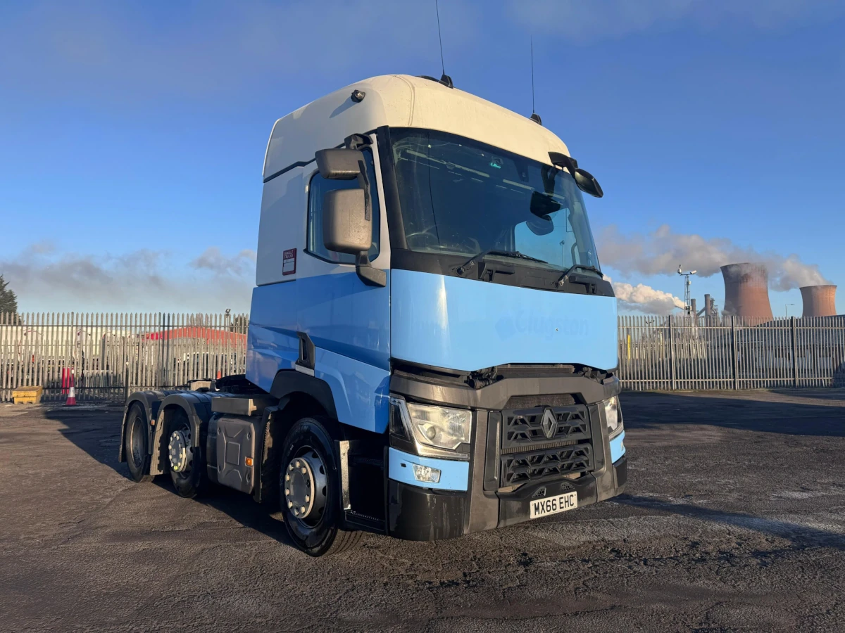 2016 Renault T480 6x2 tractor unit in blue and white, featuring 13L engine, automatic transmission, 660,276 km, MOT valid until March. Front view showing fog lamps and Renault grille, parked at industrial facility.