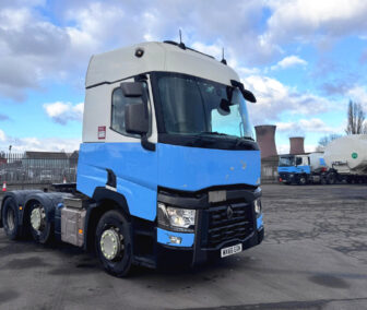 2016 Renault T480 6x2 tractor unit in blue and white livery, featuring high-roof cab and automatic gearbox, photographed at commercial vehicle depot with cooling towers in background
