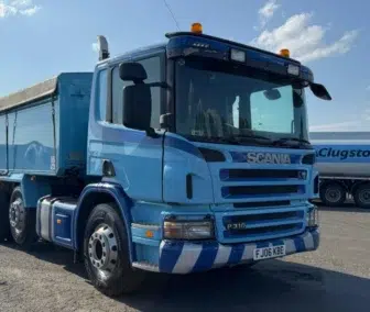 2006 Scania P310 6x2 Tipper in metallic blue, featuring insulated aluminium body, roll-over cover and rest cab configuration. Available for export from UK.