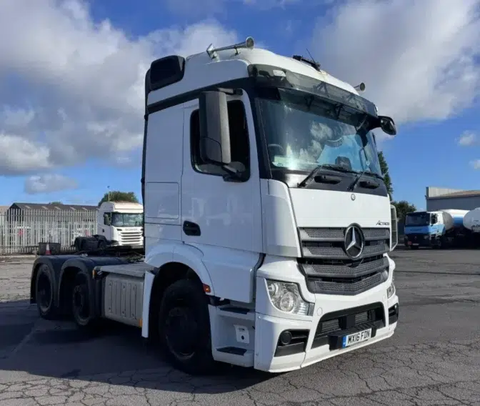 Gallery of sold trucks A clean white 2016 Mercedes Actros 2543 6x2 mid-lift tractor unit, ready for sale at a UK truck yard.